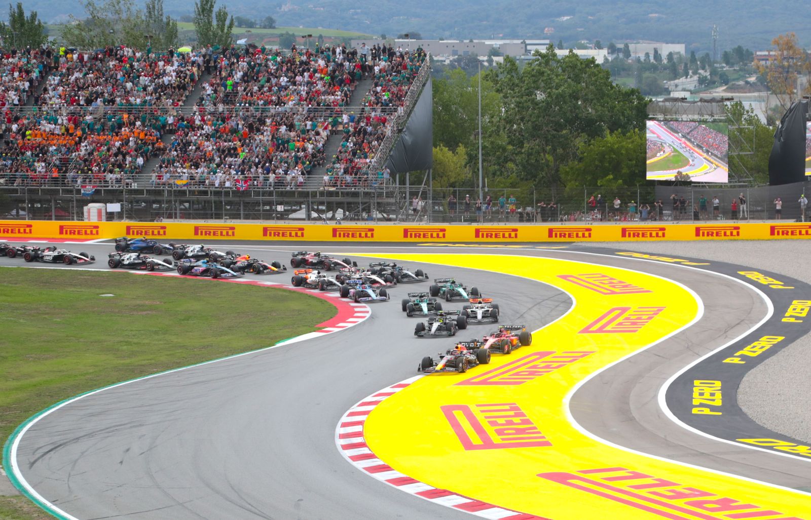 A Formula 1 car in action on a racetrack, illustrating aerodynamic and tire management challenges.