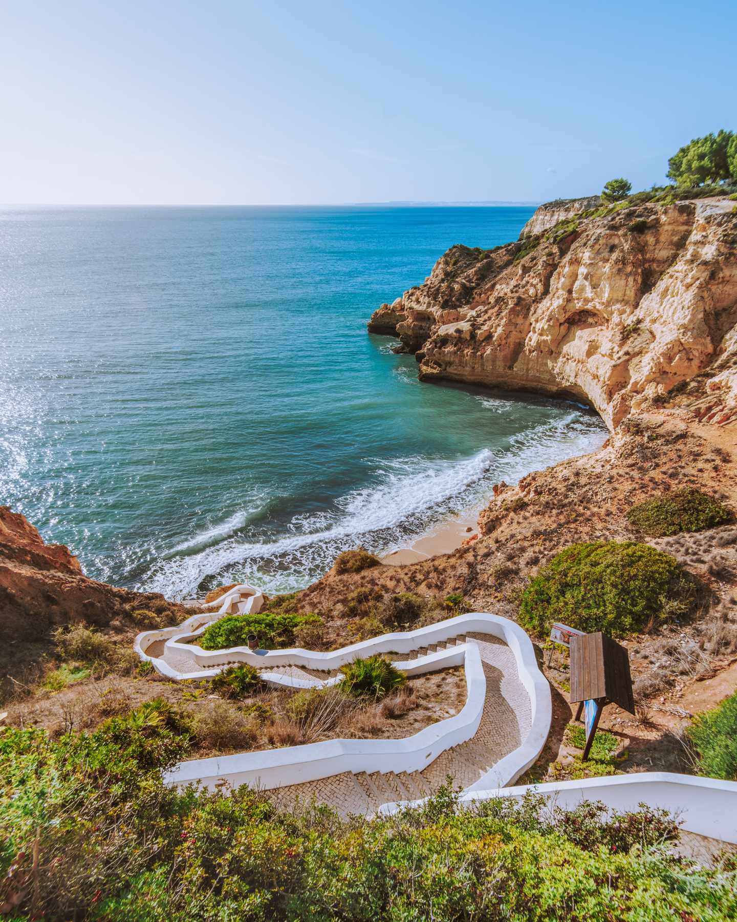 Geschwungener Küstenweg zur Praia do Paraíso mit goldenen Felsen und Atlantik an der Algarve in Portugal
