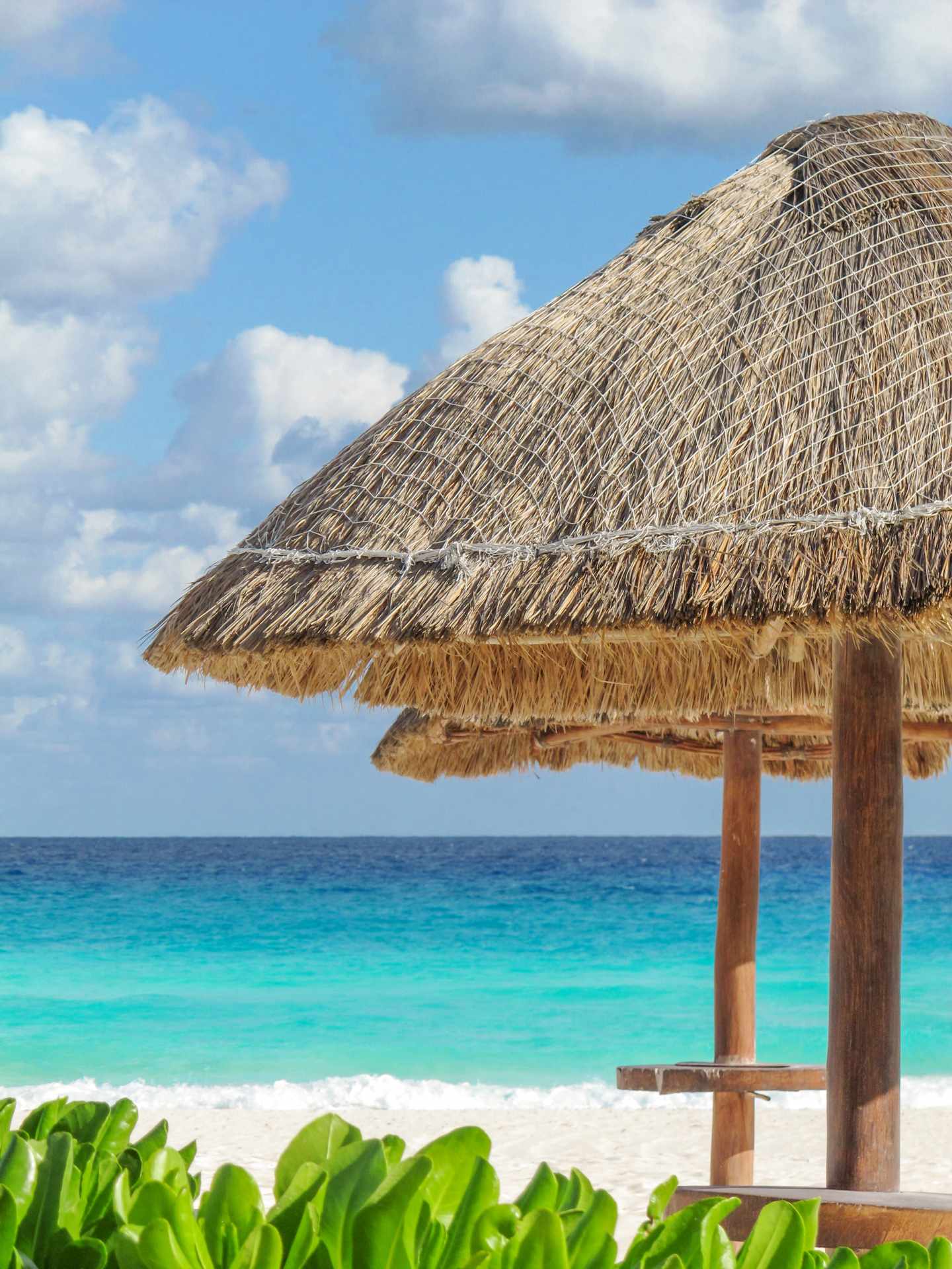 GettyImages-1147699779.jpg Mit Palmblättern gedeckte Hütte (Palapa) am weißen Sandstrand vor türkisfarbenem Meer