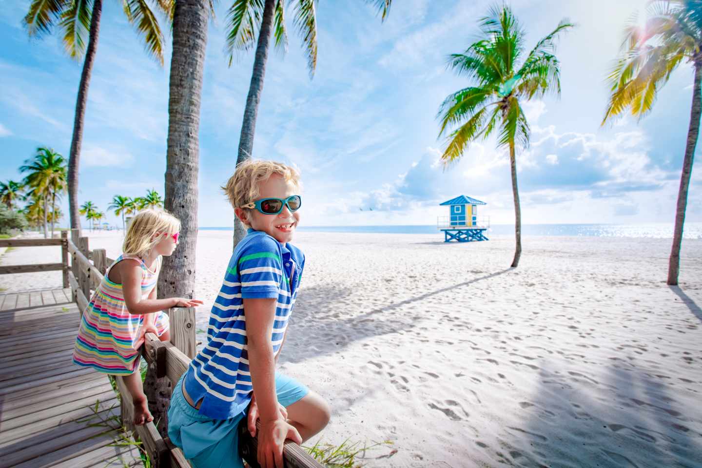 usa-florida-key-west-happy-boy-and-girl-at-tropical-beach-with-palms-g-1190635417.jpg