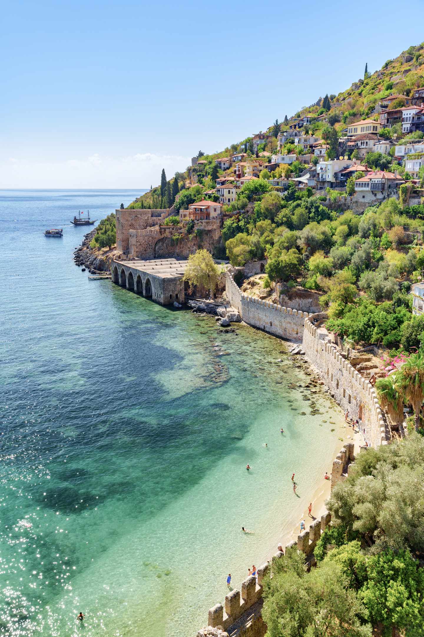 tuerkei-alanya-tersane-boote-g-1399691337.jpg Türkei Urlaub: Blick auf die historische Tersane in Alanya mit türkisblauem Wasser und bewaldeten Hügeln