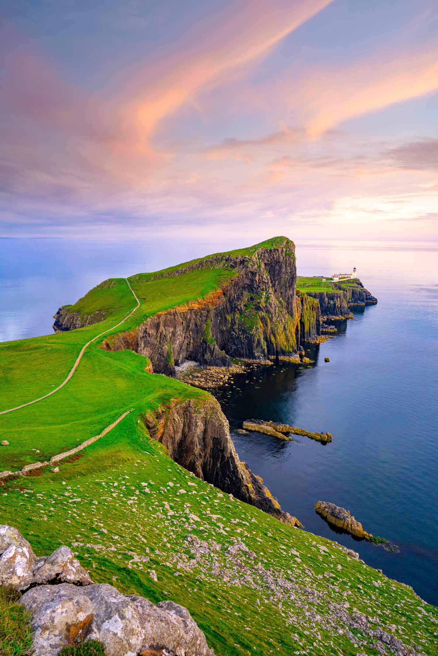 Grüne Klippen von Neist Point auf der Isle of Skye mit Küstenpfad Felsen und Blick über das Meer