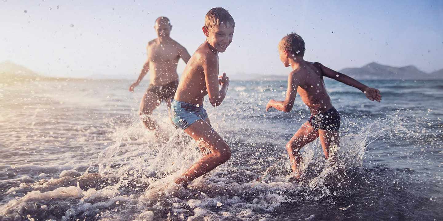 kinder-spielen-mit-vater-im-meer-g-1152074649.jpg